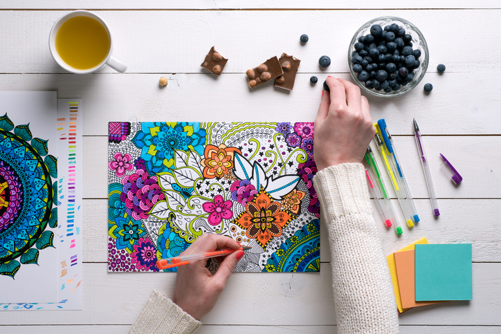 Flat lay, female coloring adult coloring books, stress relieving trend